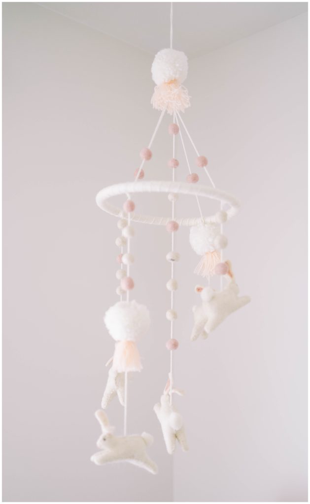 A mobile hangs in a nursery. Documenting nursery elements is one of the benefits of in-home sessions with Alpharetta Newborn Photographer Grace Emily