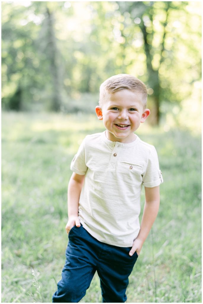 A big brother smiles in a solo shot. A great way to involve siblings in maternity photos is to take solo photos of them. Tips from Atlanta Maternity Photographer Emily Grace Photography.