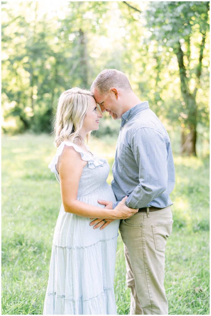 A pregnant mother and father gaze into each other's eyes. Atlanta Maternity Photographer Emily grace Photography.