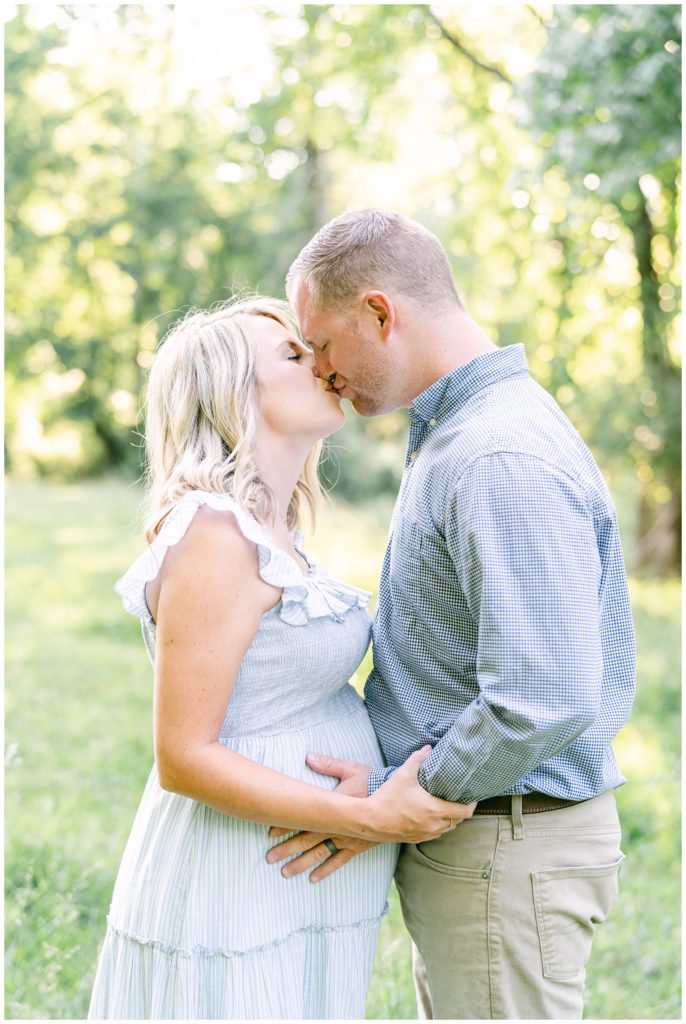 A pregnant mother and father kiss. Atlanta Maternity Photographer Emily Grace Photography.