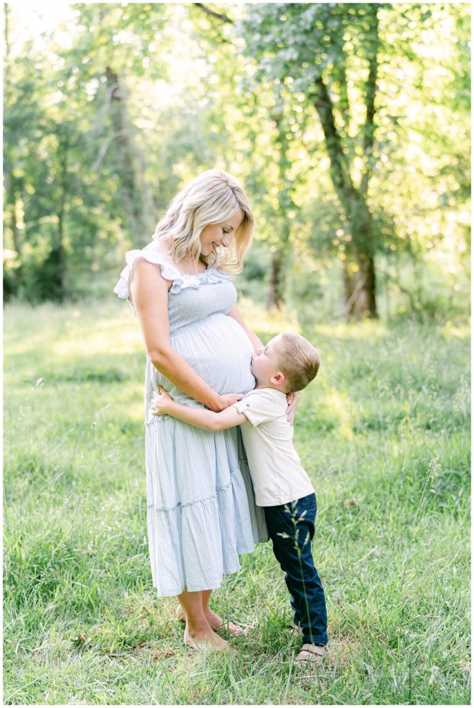 A young boy hugs his mother's pregnant belly. Atlanta Maternity Photographer Emily Grace Photography.
