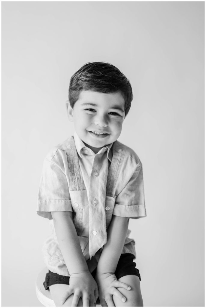 A black and white shot of a little boy smiling. Studio Photo Session, Grace Emily Photography, Alpharetta Photographer
