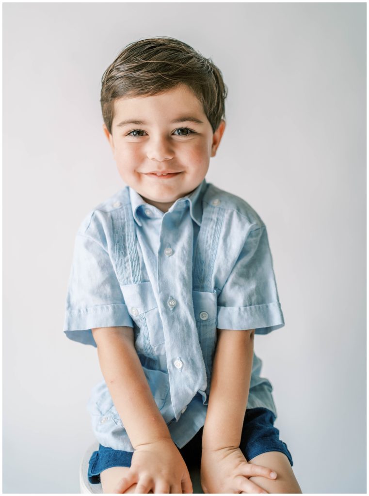 A young boy smiles at the camera. Studio Photo Sessions, Grace Emily Photography, Alpharetta Photographer
