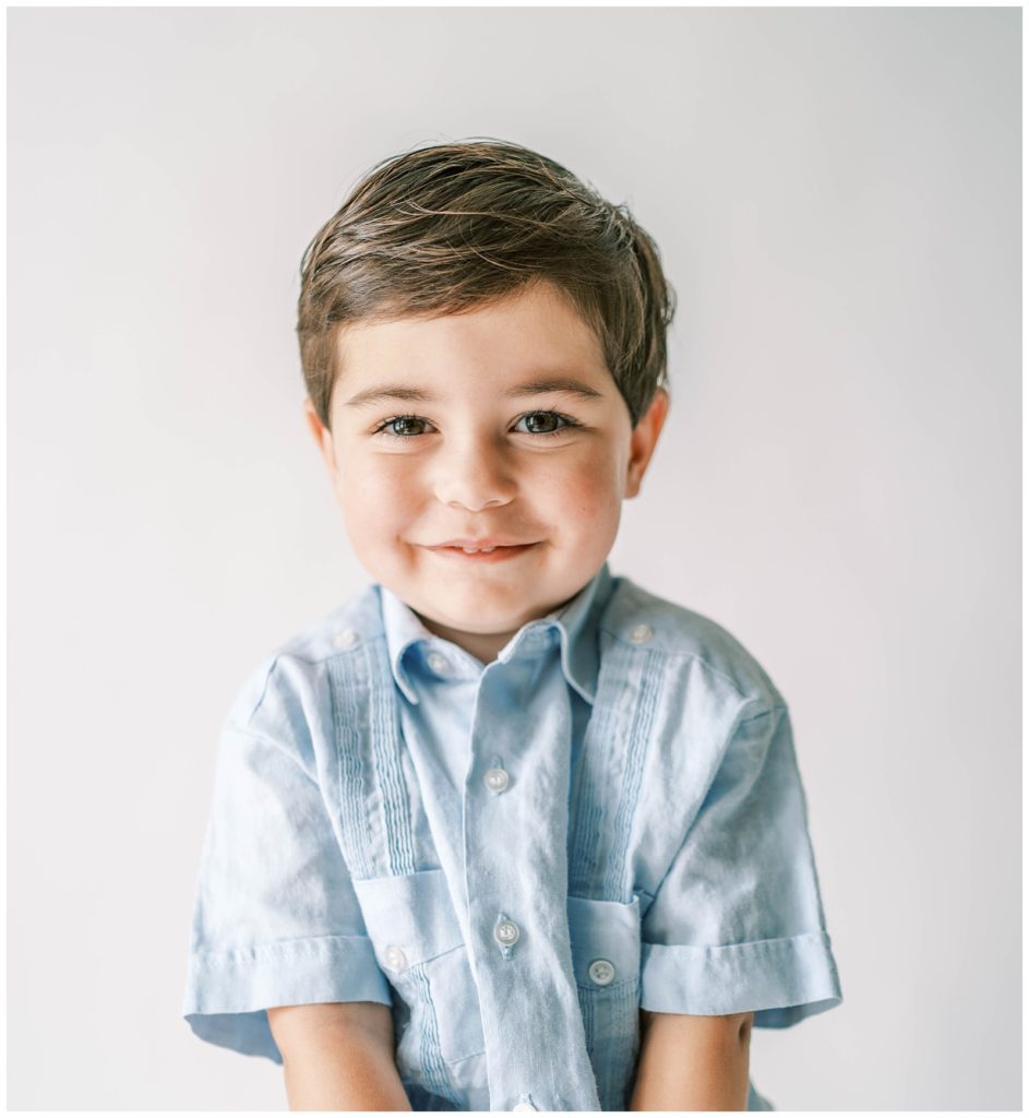 A boy smiles at the camera. Studio Photo Sessions, Grace Emily Photography, Alpharetta Photographer

