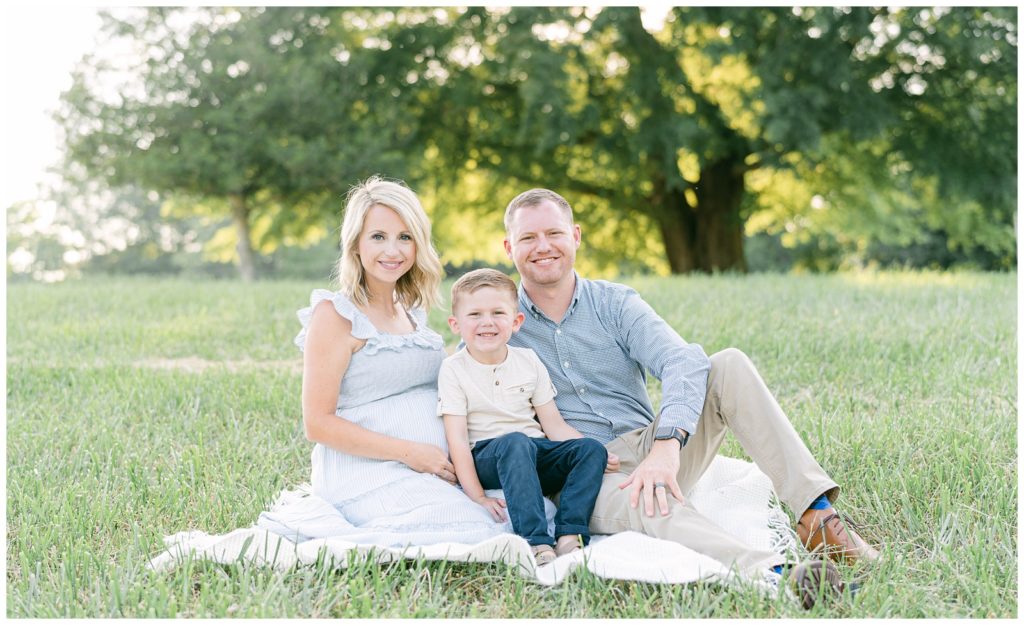 A mother, father, and son sit smiling together. Documented by North Georgia photographer Grace Emily.
