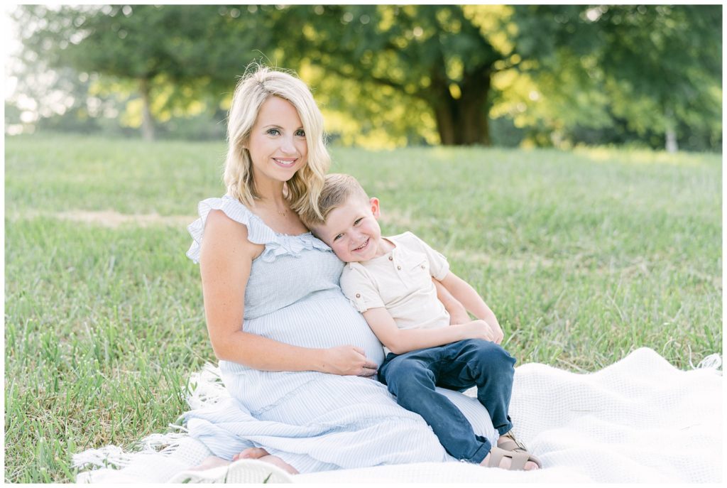 A mother and son sit smiling together. Alpharetta Photographer Grace Emily documents the moment.