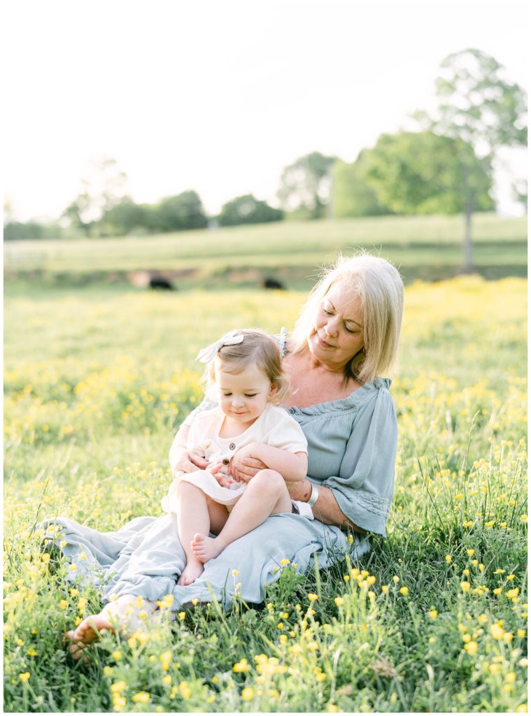 A toddler girl is held by her grandmother. North Georgia photographer Grace Emily captures the moment.