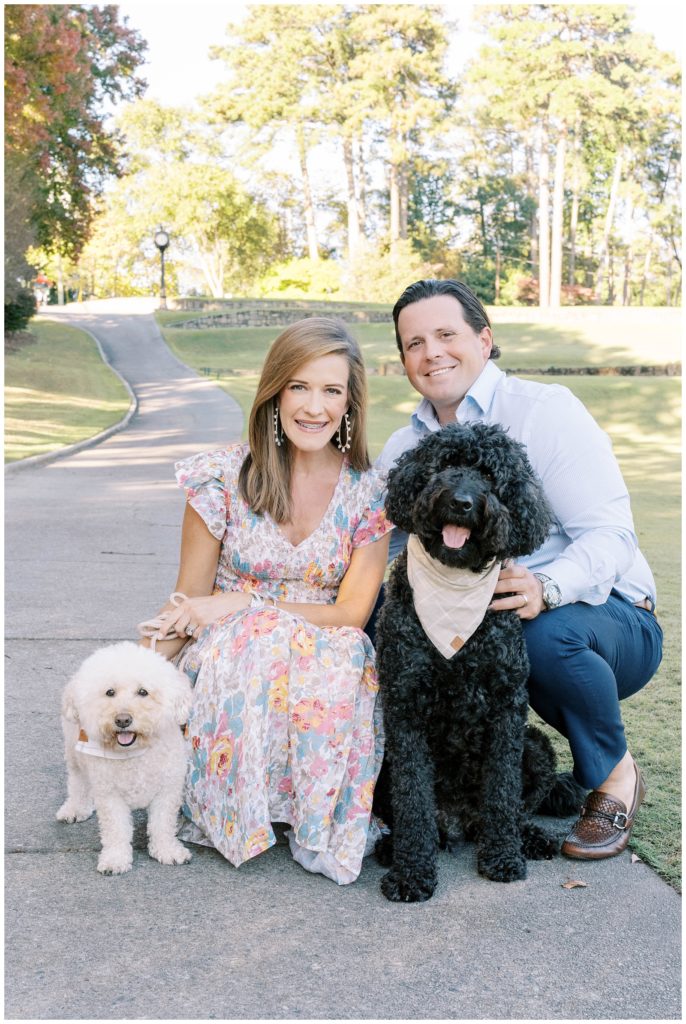 A husband and wife smile with their two dogs. Alpharetta Georgia Photographer Grace Emily documents the moment.
