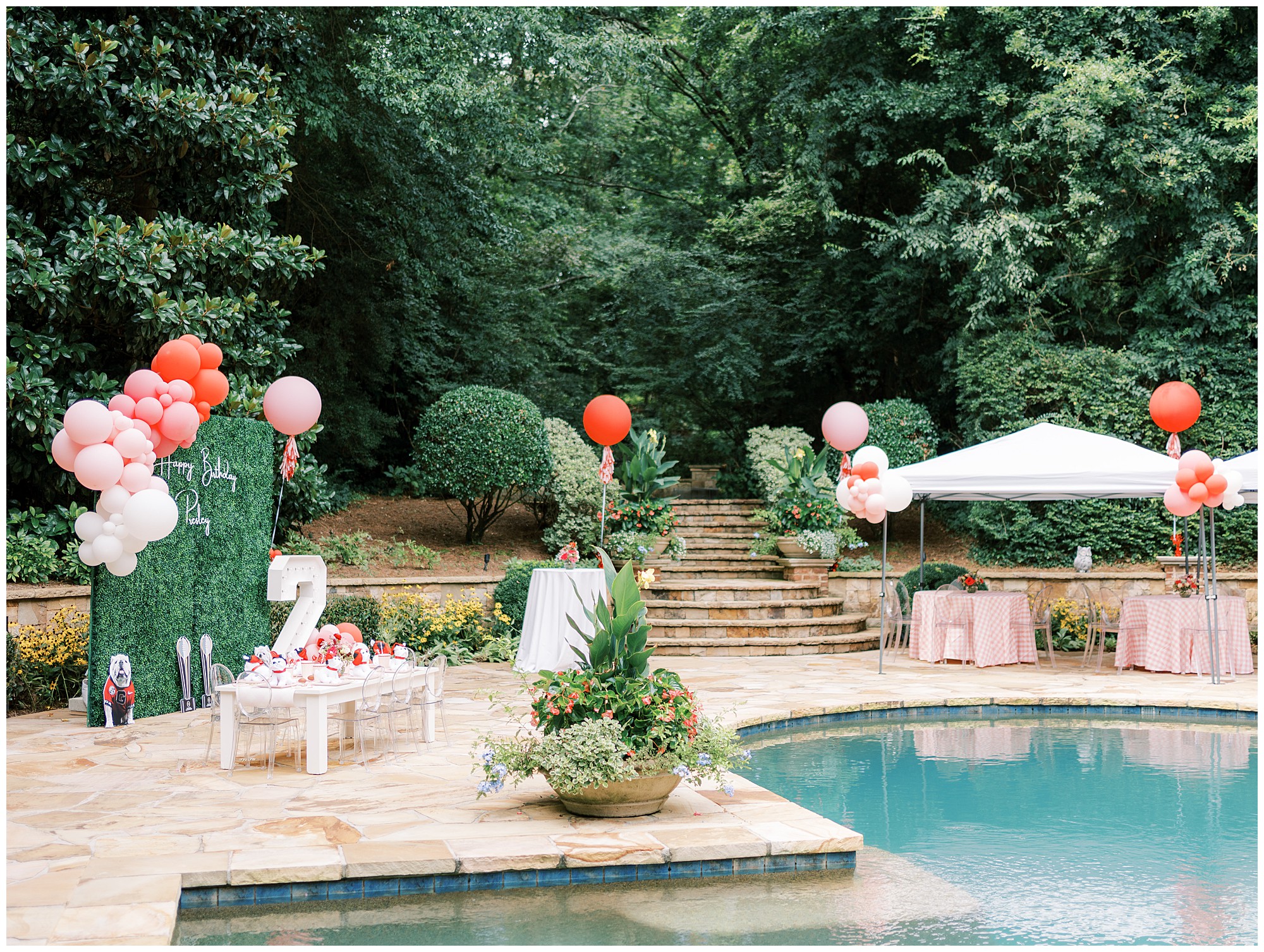 Landscape view of a pool and backyard decorated for a two year old's UGA themed birthday party.