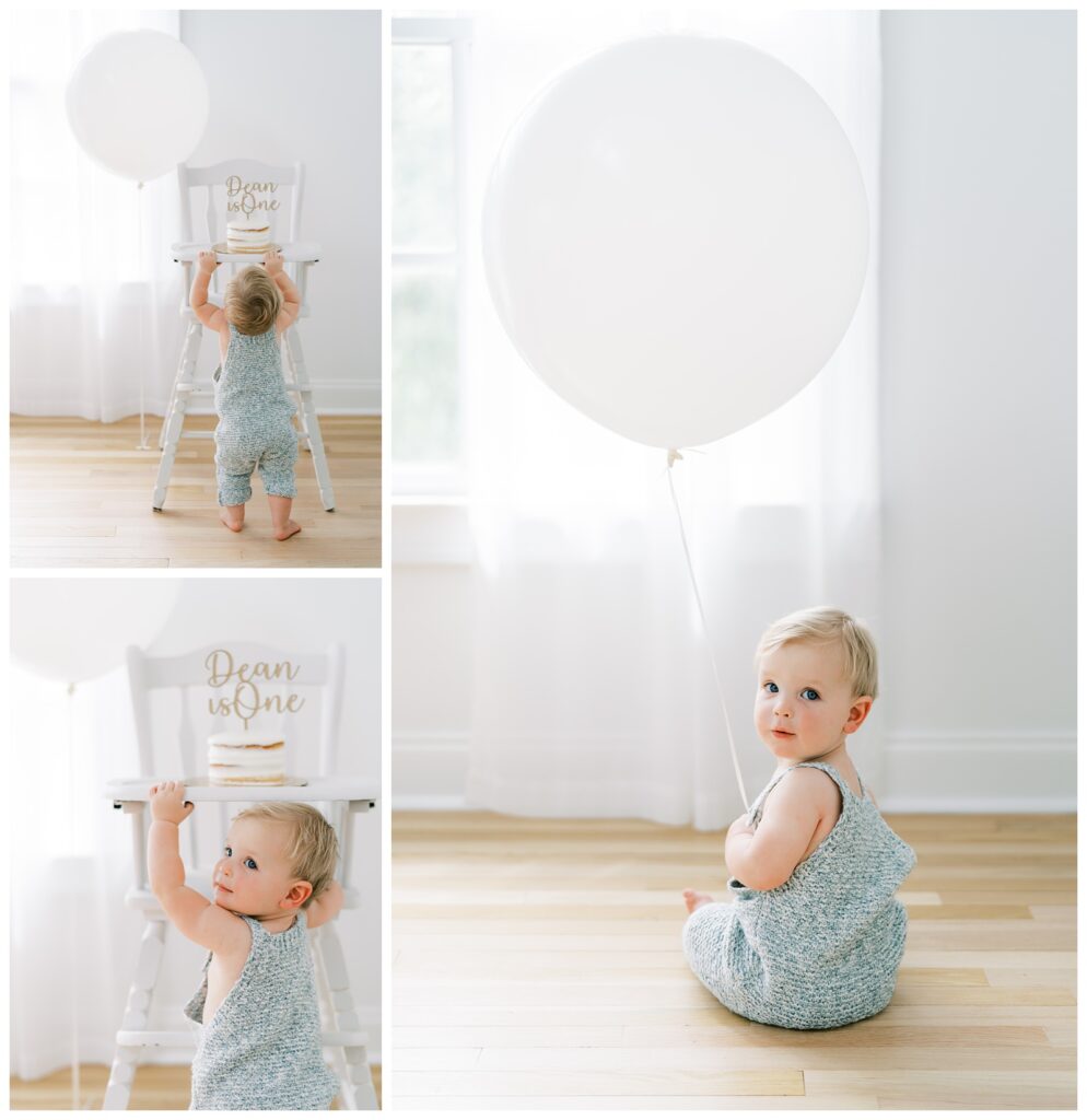 Collage of thee images of a baby standing in front of a white high chair, wearing grey overalls looking at a white birthday balloon having his portrait taken by Atlanta cake smash photographer, Grace Emily Photography.
